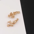 Detail of dolphin pendants with white cubic zirconia and green gem eyes for jewelry - Dolphin Shape Style
