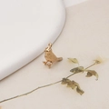 Macro shot of gold bird pendant with detailed feather texture and ring attachment - Bird Style (2#)