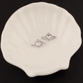 Macro shot of silver winged heart charms with crystal inlay on a shell-shaped display tray - 12# Small Winged Heart Style (Clear Rhinestone)