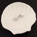 Macro detail of Y2K silver wing heart pendants with pink gemstone in white tray - 26# Small Winged Heart Style (Pink Rhinestone)