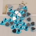 Macro detail of lake blue heart-shaped acrylic flatback rhinestones for DIY crafts - Aqua