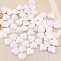 Macro shot of 12mm white acrylic heart flatback cabochons with glossy finish - Solid White