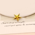 Macro detail of amber star-shaped acrylic rhinestone with faceted cut for DIY crafts - 20mm Star / Gold Yellow