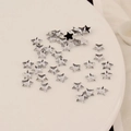 Detailed macro view of 6mm star shaped acrylic flatback rhinestones for DIY nail art - 6mm Pentagram / Clear White