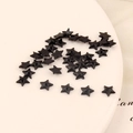 Macro view of 6mm black star acrylic rhinestones for DIY crafts and nail art design - 6mm Pentagram / Black