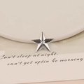 Detailed macro view of star-shaped 20mm faceted acrylic gem with silver metallic luster - 20mm Star / Clear White