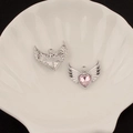 Detailed view of silver angel wing heart charms with pink zircon in a shell tray - 8# Large Winged Heart Style (Pink Rhinestone)