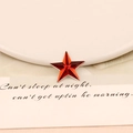 Macro view of red star-shaped acrylic rhinestone with faceted cut and silver trim - 20mm Star / Red