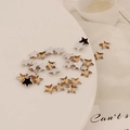 Macro shot of 6mm silver and champagne gold star acrylic flatback rhinestones for DIY crafts - 6mm Pentagram / Champagne