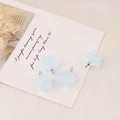 Macro shot of four light blue acrylic star pendants with silver rings for DIY jewelry - Sky Blue