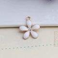 Detailed macro of golden alloy five-petal flower pendant with white enamel and center crystal - 18*20mm / White Flower (DFC128WH)