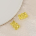 Macro shot of yellow transparent resin gummy bear charms for DIY jewelry making - Yellow