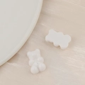 Macro shot of white resin cartoon bear charms for DIY handmade crafts and hair accessories - White