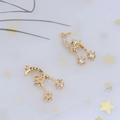 Macro detail of gold moon and star pendants with zirconia inlays and dangling tassels - Style 3 Celestial Tassel / 100 Units Pack
