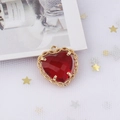 Macro shot of gold-plated heart pendant with faceted red zircon and lace-cut metal edges - Wine Red (9#)