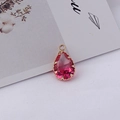 Vue macro d'un pendentif en cristal rose dégradé en forme de goutte et serti doré - 10*19MM