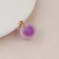 Detailed macro view of a matte purple gradient bubble bead pendant with a gold metal ring - 16mm / Purple