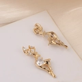 Detail view of gold reindeer pendants with cubic zirconia on elegant satin background - Reindeer
