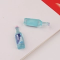Close-up of blue and pink miniature beverage bottles for DIY cream glue phone case crafts - Blue