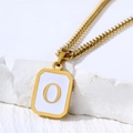 Gold stainless steel necklace with letter O pendant featuring shell inlay on white rock - Letter O