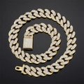 Iced out gold Cuban link chain necklace with sparkling crystals on black mirror surface - Short / Gold