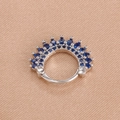 Macro shot of silver clicker earring with dark blue round gemstones in a crown design - Silver Dark Blue Style