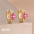 Macro shot of a 6mm golden huggie earring with a pink zircon four-leaf clover design - 6mm-Gold Rose Red-1 Pair
