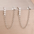 Macro shot of silver zircon chain earrings hanging on a champagne jewelry box edge - Silver White Style (Y26305)