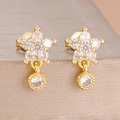 Macro shot of gold floral earrings with sparkling cubic zirconia crystals on gray display - Gold White Style (Y27213)