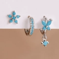 Detailed macro view of silver floral earrings with blue gems and a butterfly charm set - Y27392 Silver Blue