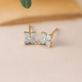 Detailed macro shot of light blue floral stud earrings with gold plating and zircons - Four-Leaf Flower Studs (Y20310) / Gold