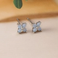 Macro detail of clover-shaped stud earrings with white opal stones and silver finish - Four-Leaf Flower Studs (Y20310) / Silver