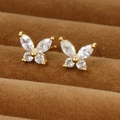 Exquisite gold butterfly earrings featuring sparkling zircon wings on a velvet display - Large Gold