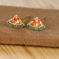Macro shot of 18K gold watermelon stud earrings with orange and green sparkling zircons - Watermelon