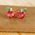 Macro view of heart shaped red zircon fruit earrings with 18K gold plated leaves - Apple