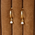 Close-up of 18K gold hoop earrings featuring clear round cubic zirconia dangles - Solitaire Pendant Style / Gold (Y20301)