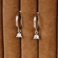 Macro shot of silver hoops with sparkling cubic zirconia on a brown velvet stand - Solitaire Pendant Style / Silver (Y20301)