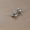Macro shot of silver stainless steel triple ball stud earring with secure screw-back closure - Three-Ball Triangle Style (Y20419-1) / Silver