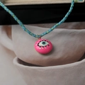 Detail of pink evil eye pendant with blue and green hand-woven rope and golden clasp - Evil Eye Style / Pink