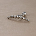 Gros plan sur un piercing en acier inoxydable argenté avec perles en métal poli dégradé - Style Grand Arc Dégradé à Sept Boules (Y20419-8) / Argent