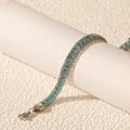 Macro view of a silver stainless steel bracelet with blue cubic zirconia and lobster clasp - Silver Sea Blue Zirconia
