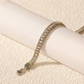Macro detail of double-row stainless steel bracelet with iridescent crystals and lobster clasp - Silver Opal Color Zirconia