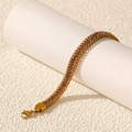 Macro shot of double-chain gold bracelet with purple square-cut cubic zirconia and lobster clasp - Gold Purple Zirconia