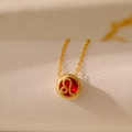 Gold Leo zodiac necklace featuring a round red gemstone pendant on a fine chain link - Leo