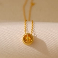 Golden double-sided zodiac necklace featuring a yellow round zircon with an anchor motif - Sagittarius