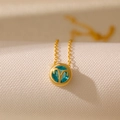 Golden Aries zodiac necklace with a blue gemstone pendant on a fine circular chain - Aries