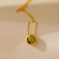 Golden Virgo zodiac necklace featuring a green peridot-style stone and镂空 design - Virgo