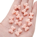Perline a fiocco rosa in acrilico per gioielli fai da te mostrate sulla mano per scala - Rosa Arancio