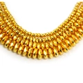 Detail of multi-layered gold beaded necklace with faceted oval beads and metallic shine - 3mm x 2mm (Approx. 190 Pcs/Pack) / Gold