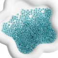 Bulk 4mm water blue transparent glass seed beads with center hole in a white ceramic dish - 4mm (10g/Pack) / Peacock Green